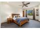 Bright bedroom with a ceiling fan, carpeted floor, and a view to the outside from the window at 10267 E Cinder Cone Trl, Scottsdale, AZ 85262