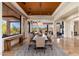 The dining area includes a large table and chairs with backyard views, transitioning to the living area and kitchen at 10267 E Cinder Cone Trl, Scottsdale, AZ 85262