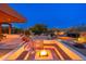 A luxurious outdoor fire pit, recessed into brick patio, features built-in seating at 10267 E Cinder Cone Trl, Scottsdale, AZ 85262