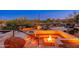 Inviting outdoor firepit area with built-in seating and desert views at 10267 E Cinder Cone Trl, Scottsdale, AZ 85262