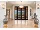 Elegant foyer with high ceilings, marble floors, grand doors, and stylish decor, creating a luxurious entrance at 10267 E Cinder Cone Trl, Scottsdale, AZ 85262