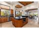 This open concept kitchen with a center island and stainless steel appliances leads into the dining and living spaces at 10267 E Cinder Cone Trl, Scottsdale, AZ 85262