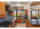 This gourmet kitchen features high-end appliances, custom cabinetry, and a backsplash, offering a view of the dining area at 10267 E Cinder Cone Trl, Scottsdale, AZ 85262