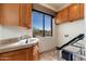 Laundry room with a window with a view to the outside plus built in cabinets and countertop at 10267 E Cinder Cone Trl, Scottsdale, AZ 85262