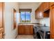 Laundry room with gray washer and dryer, built-in cabinets, and a sink at 10267 E Cinder Cone Trl, Scottsdale, AZ 85262