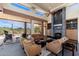 Inviting living room with a stone fireplace, built-in shelving, and panoramic views, perfect for relaxing and entertaining at 10267 E Cinder Cone Trl, Scottsdale, AZ 85262