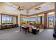Spacious living room featuring expansive windows with scenic views, a wet bar and comfortable seating at 10267 E Cinder Cone Trl, Scottsdale, AZ 85262