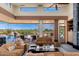 Bright living room boasts a ceiling fan, comfortable sofas, modern decor, and a sliding glass door to a patio with a pool at 10267 E Cinder Cone Trl, Scottsdale, AZ 85262