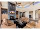 Elegant living room with a stone fireplace, built-in cabinetry, and stylish furnishings, perfect for relaxation at 10267 E Cinder Cone Trl, Scottsdale, AZ 85262