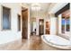 Spacious primary bathroom features a soaking tub, walk-in shower, and elegant tile work at 10267 E Cinder Cone Trl, Scottsdale, AZ 85262