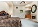 Primary bedroom with a fireplace, a ceiling fan, and carpeted floors at 10267 E Cinder Cone Trl, Scottsdale, AZ 85262