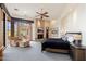 Comfortable primary bedroom has fireplace, outdoor access, and a relaxing seating area at 10267 E Cinder Cone Trl, Scottsdale, AZ 85262