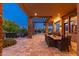 Covered patio includes an outdoor dining area with stone pillars and beautiful backyard views at 10267 E Cinder Cone Trl, Scottsdale, AZ 85262