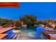 Tranquil pool reflecting the night sky, set amidst desert landscaping and lighting at 10267 E Cinder Cone Trl, Scottsdale, AZ 85262