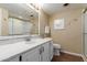 Bathroom with white cabinets, a large vanity mirror, and a shower at 10330 W Thunderbird Blvd # A301, Sun City, AZ 85351