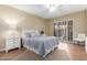 Bedroom with neutral walls, a ceiling fan, and sliding glass doors to the balcony at 10330 W Thunderbird Blvd # A301, Sun City, AZ 85351