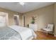 Cozy bedroom with wood floors, closet, ceiling fan, and a chair with a teddy bear at 10330 W Thunderbird Blvd # A301, Sun City, AZ 85351