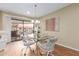 Bright dining area featuring a glass table, stylish chairs, and access to the outdoor balcony at 10330 W Thunderbird Blvd # A301, Sun City, AZ 85351