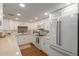 Bright and modern kitchen featuring white cabinetry, hardwood floors, stainless steel appliances and ample counter space at 10330 W Thunderbird Blvd # A301, Sun City, AZ 85351