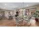 Open-concept living room and dining area with hardwood floors and a sliding glass door to the balcony at 10330 W Thunderbird Blvd # A301, Sun City, AZ 85351