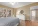 Bedroom featuring neutral walls and balcony access through shuttered sliding doors at 10330 W Thunderbird Blvd # A301, Sun City, AZ 85351