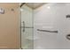 Bright shower stall with glass doors and accessible grab bars and seating at 10330 W Thunderbird Blvd # A301, Sun City, AZ 85351