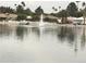 A tranquil waterfront view showcasing a fountain in the water and residential homes on the opposite shore at 10330 W Thunderbird Blvd # A301, Sun City, AZ 85351
