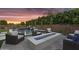 Inviting backyard featuring a pool with waterfall, spa, fire pit, and lounge seating at 10353 E Trillium Ave, Mesa, AZ 85212
