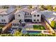 Aerial view of backyard oasis with pool, pergola with grill, patio seating and a manicured lawn at 10353 E Trillium Ave, Mesa, AZ 85212