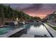 Backyard with a pool, spa, and outdoor kitchen set against a vibrant sunset at 10353 E Trillium Ave, Mesa, AZ 85212