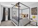 Modern bedroom with a four-poster bed, stylish decor, and a cozy atmosphere with plenty of natural light at 10353 E Trillium Ave, Mesa, AZ 85212