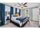 Cozy bedroom with a ceiling fan, plush carpet, and natural light at 10353 E Trillium Ave, Mesa, AZ 85212
