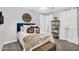 Comfortable bedroom with a stylish bed, decorative shelving, and soft, sheer curtains for a serene ambiance at 10353 E Trillium Ave, Mesa, AZ 85212