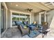 Covered patio showcasing comfortable seating, a ceiling fan, and views of the backyard at 10353 E Trillium Ave, Mesa, AZ 85212