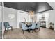 Elegant dining room with modern chandelier, stylish chairs, and well placed buffet table at 10353 E Trillium Ave, Mesa, AZ 85212
