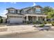 Charming two-story home features a well-manicured lawn, gray paint, and a spacious two car garage at 10353 E Trillium Ave, Mesa, AZ 85212