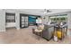Comfortable living room featuring hardwood floors, modern decor, and sliding glass door to a backyard oasis at 10353 E Trillium Ave, Mesa, AZ 85212