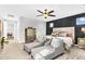 Spacious main bedroom featuring a decorative ceiling fan, sitting area, and ensuite bathroom access at 10353 E Trillium Ave, Mesa, AZ 85212