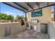 Covered outdoor kitchen featuring stainless steel appliances and a built-in barbecue at 10353 E Trillium Ave, Mesa, AZ 85212