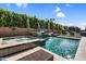 Sparkling pool and spa with waterfalls surrounded by lush landscaping and stone pavers at 10353 E Trillium Ave, Mesa, AZ 85212