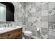 Modern powder room with unique black and white patterned tile walls and stylish fixtures at 11385 N Luckenbach St, Surprise, AZ 85388