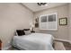 Comfortable bedroom with wood flooring, white shutters, and a decorative ceiling light at 11385 N Luckenbach St, Surprise, AZ 85388