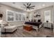 A well lit bedroom with plantation shutters, wood-like flooring, and neutral decor at 11385 N Luckenbach St, Surprise, AZ 85388