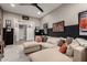 Comfortable bonus room with a cozy sectional sofa, movie posters, and an open doorway at 11385 N Luckenbach St, Surprise, AZ 85388