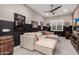 Comfortable bonus room with a cozy sectional sofa, movie posters, and a barrel at 11385 N Luckenbach St, Surprise, AZ 85388