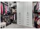 Walk-in closet featuring custom shelving, built-in drawers, and ample storage space at 11385 N Luckenbach St, Surprise, AZ 85388