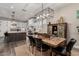 View of the dining room with a wooden table and chairs, plus a partial view of the modern kitchen at 11385 N Luckenbach St, Surprise, AZ 85388