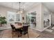 A dining room with a wooden table, black leather chairs, and sliding doors to an outdoor space at 11385 N Luckenbach St, Surprise, AZ 85388