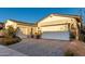Paver driveway leading to a three-car garage complementing the light-colored home at 11385 N Luckenbach St, Surprise, AZ 85388