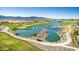 Scenic aerial shot of a golf course, showcasing a water feature, landscaping, and mountain backdrop at 11385 N Luckenbach St, Surprise, AZ 85388